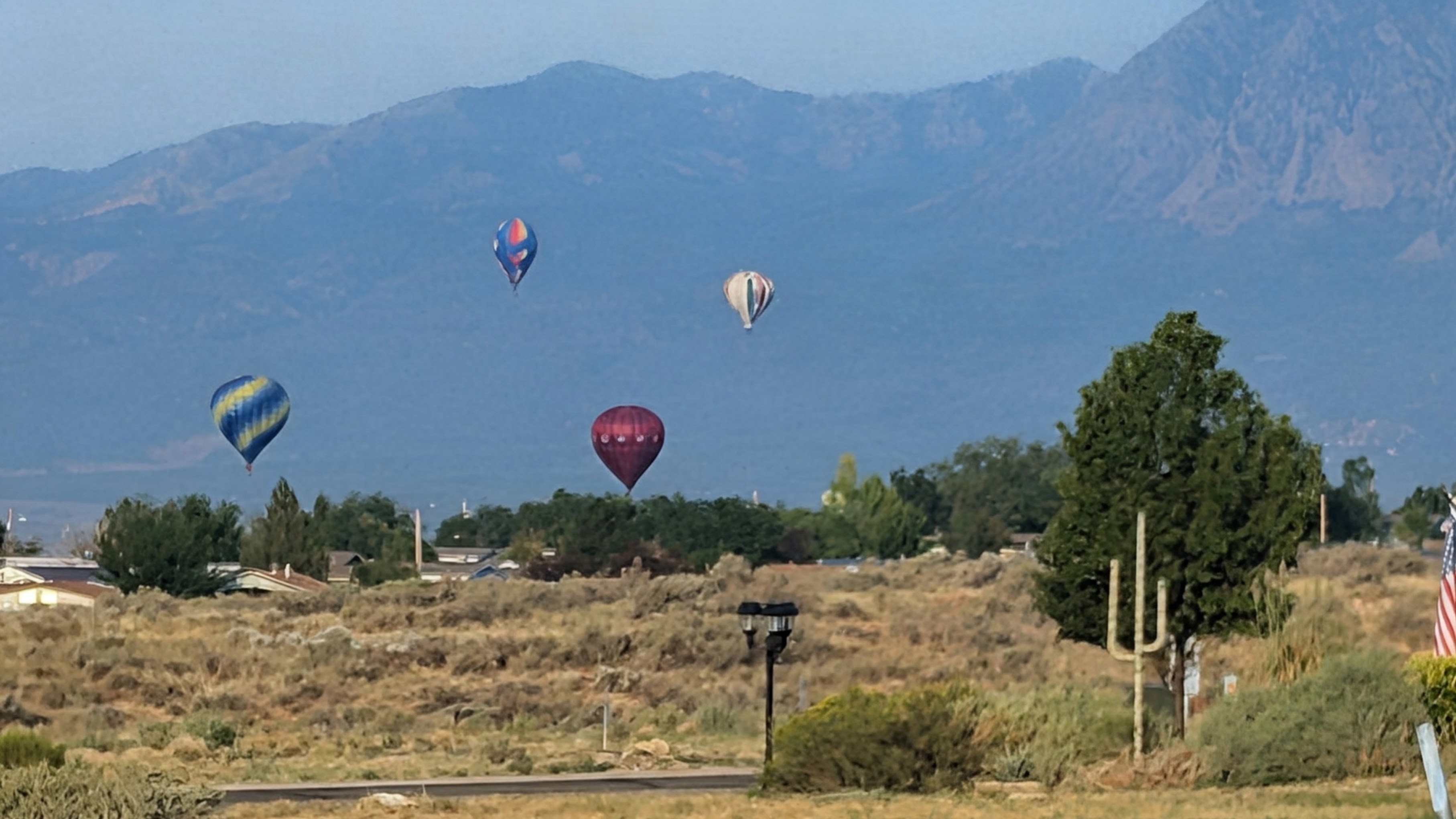 Hot air balloons floating over Cortez with mountains in the background